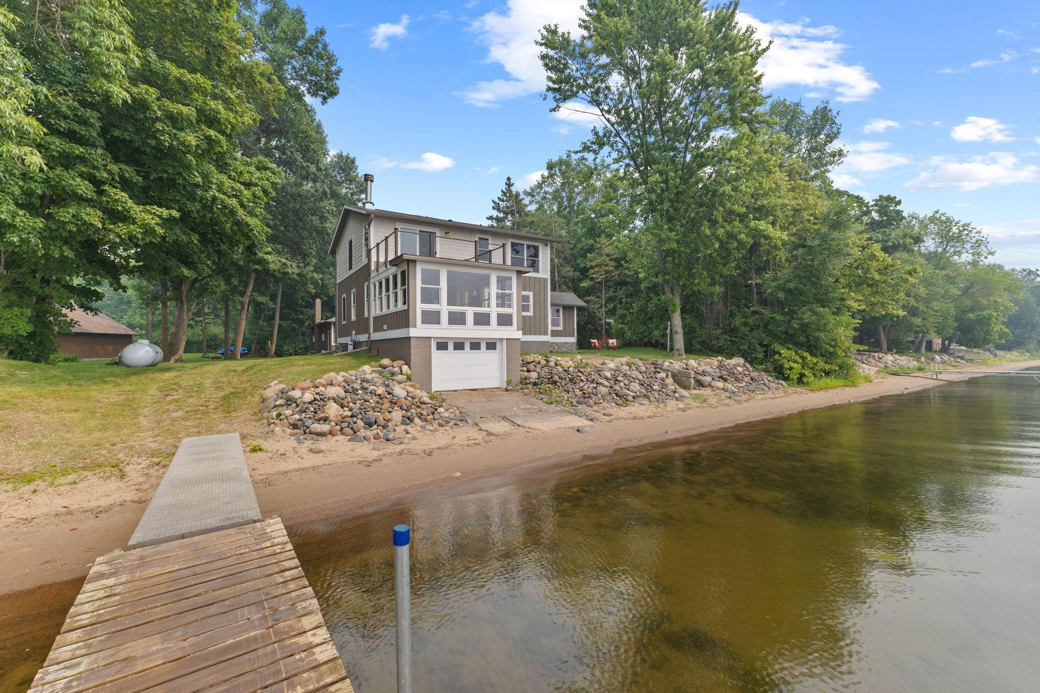 Situated on nearly 100 feet of sandy shoreline in a protected bay, this setting is ideal for swimming, fishing, boating, and making lifelong memories!