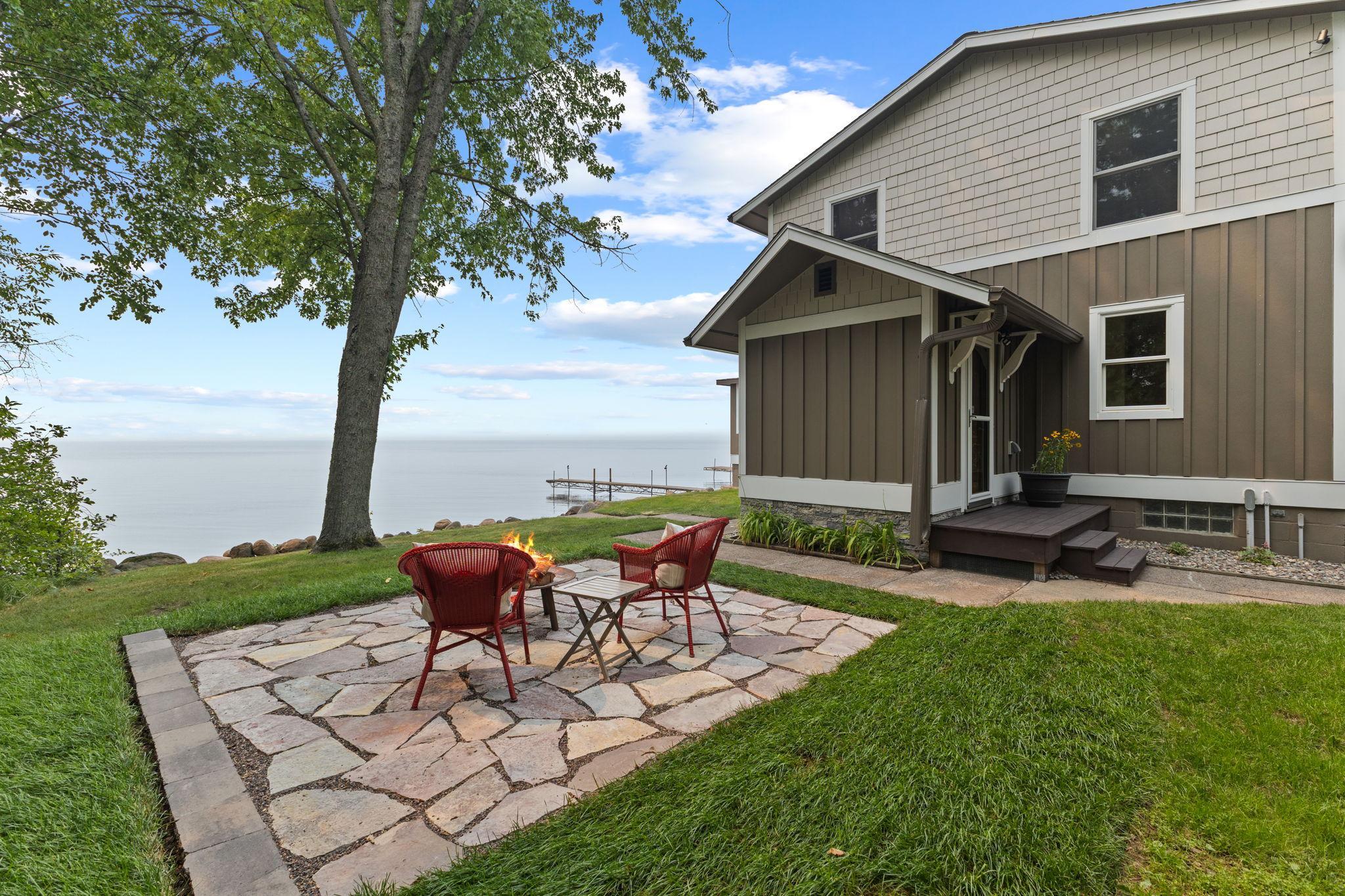 The new limestone patio creates an exceptional gathering space for enjoying fireside conversations and breathtaking sunsets.