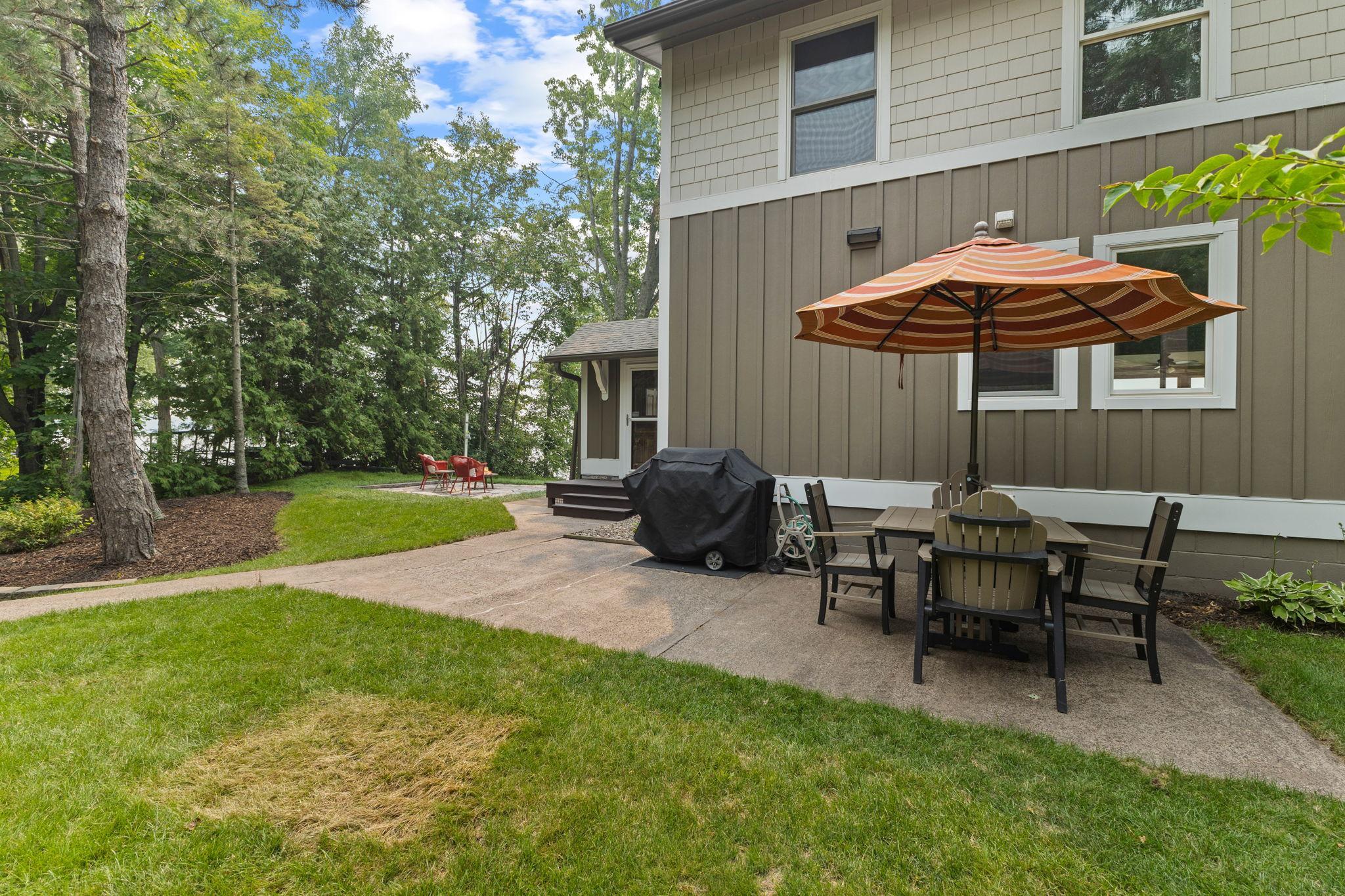 Enjoy outdoor entertaining on the expansive patio, offering convenient access to both the home and garage while overlooking the beautifully landscaped grounds.