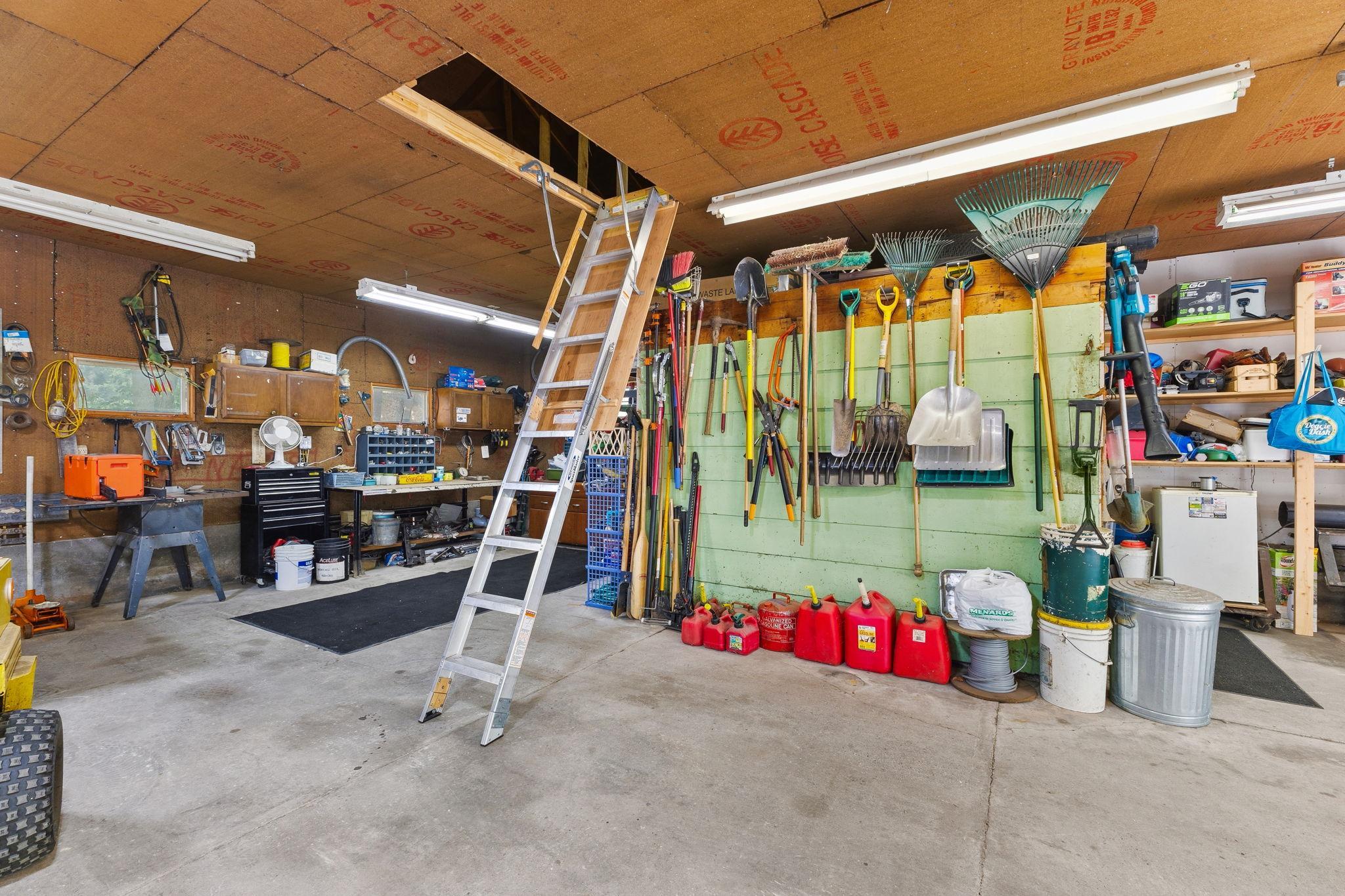 A dedicated workshop area, pull-down loft access, and abundant storage make this 37x35 garage as functional as it is spacious.