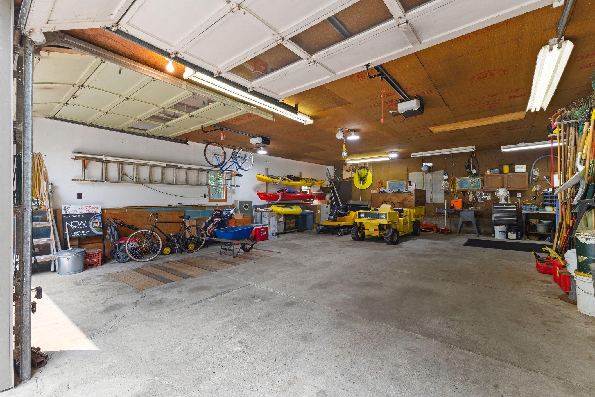 The oversized insulated 4+ car garage provides exceptional space for vehicles, boats, ATVs, and workshop projects, with 200-amp service, RV hookup, and room for all your lake toys.