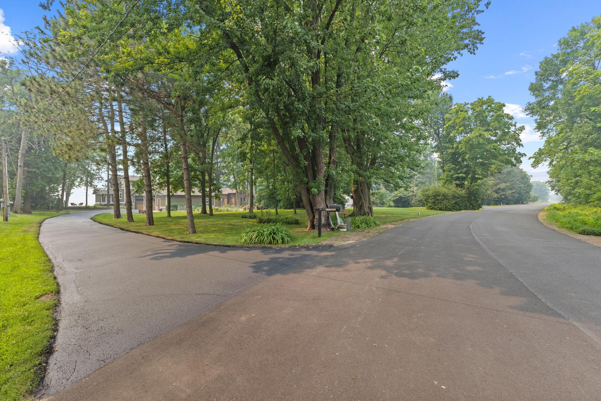 Nestled well back from the road, this exceptional home is located on the coveted east side of the lake, surrounded by mature trees and peaceful natural beauty.