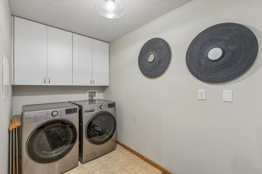 Laundry is not a chore here! Full size front load washer/dryer. Laundry cabinets to ceiling offer great storage.