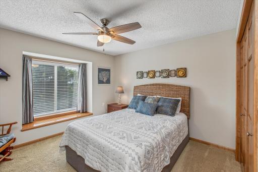 Guest bedroom also has a bench seat and large closet. Note the six panel doors throughout.