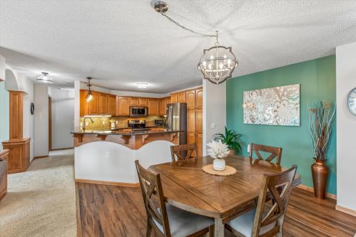 Dining room works with expanded table of any size! Hallway graced with wood columns at den entrance.