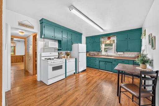 Spacious kitchen with abundant cabinetry, generous counter space and hardwood flooring.