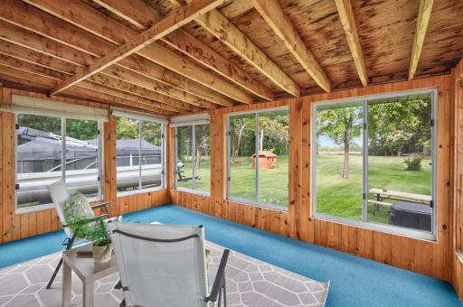 Three-season porch offers a peaceful spot to relax while taking in the surrounding scenery.