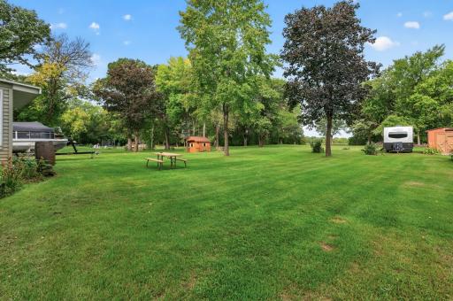 Expansive green space and mature trees create a wonderfully private backyard setting.