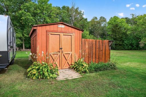 Outdoor storage shed adds convenient space for lawn and garden essentials.