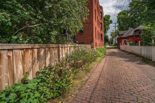 The home sits on a quiet street bordered by a charming cobblestone alley, with private yards and backyard gardens.