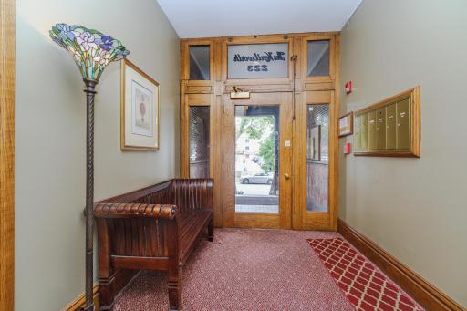 Inside the entry, this charming lobby offers a place to sit as you wait for guests and look through the mail.