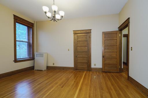 A walk-in closet is behind the door, center of photo.