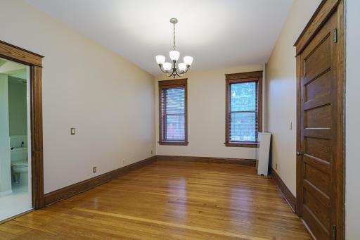 The primary bedroom is generous and has two windows and hardwood floors.