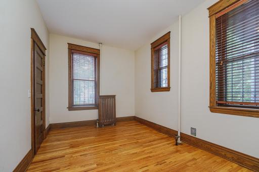 The rear bedroom has unique staggered windows and closet organizers.