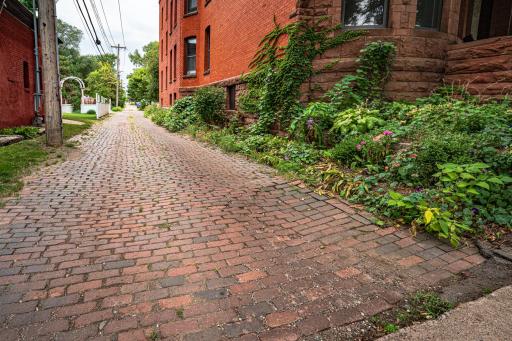 The home sits on a quiet street bordered by a charming cobblestone alley, with private yards and backyard gardens.