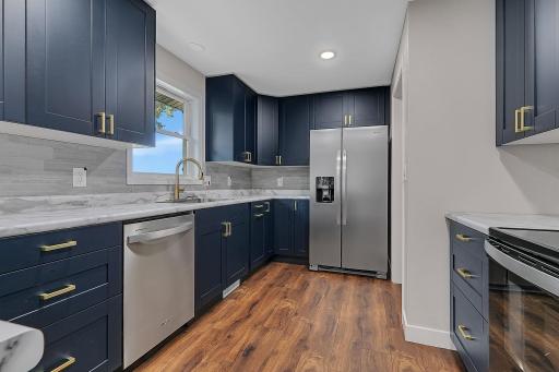 The eat-in kitchen features a full suite of brand new S.S. appliances including an electric range, dishwasher, refrigerator, and a microwave.