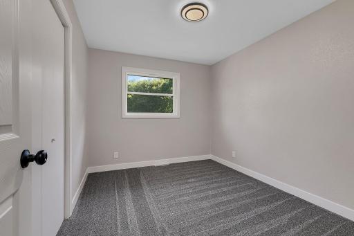The third of three bedrooms on the main floor. All three bedrooms feature brand new carpet, trim, and paint.