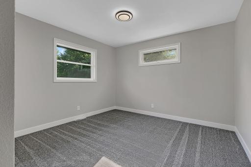 The second of three main floor bedrooms. All three bedrooms feature brand new carpet, trim, and paint.