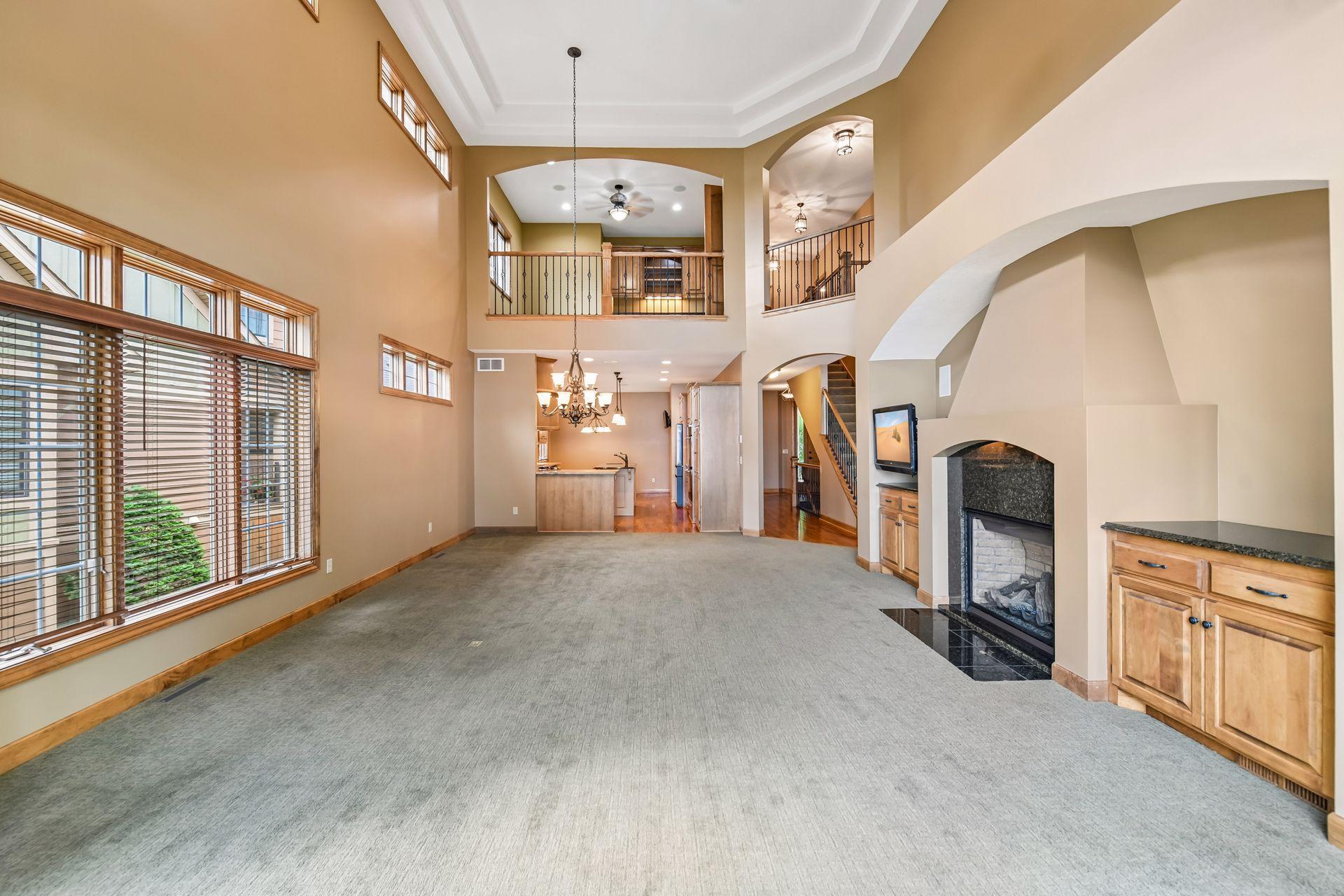 Beautiful two-story vaulted ceilings in the living room with abundant natural light.
