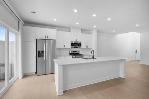 At the focal point of this modern kitchen is a quartz-topped center island to add bar-style seating, complemented by extensive cabinetry room and all-new stainless steel appliances to craft delicious meals.