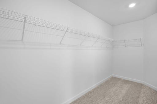 This oversized walk-in closet with built-in shelving optimizes wardrobe organization