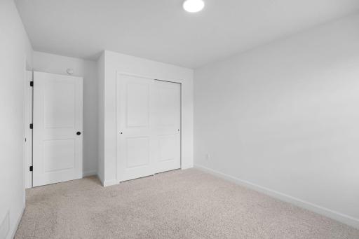 All bedrooms in the home include plush wall-to-wall carpeting and practical wardrobe closets