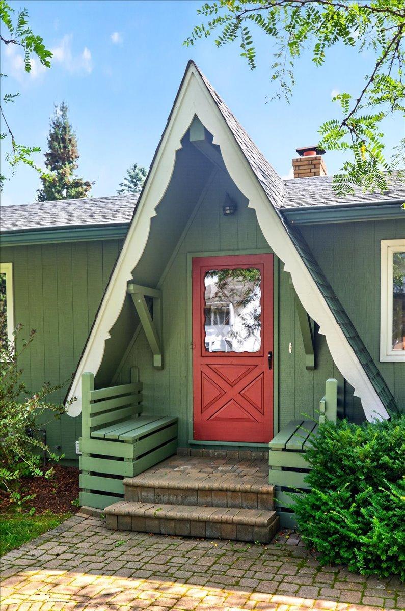 Front portico boasts cozy architectural details and built-in bench seating.
