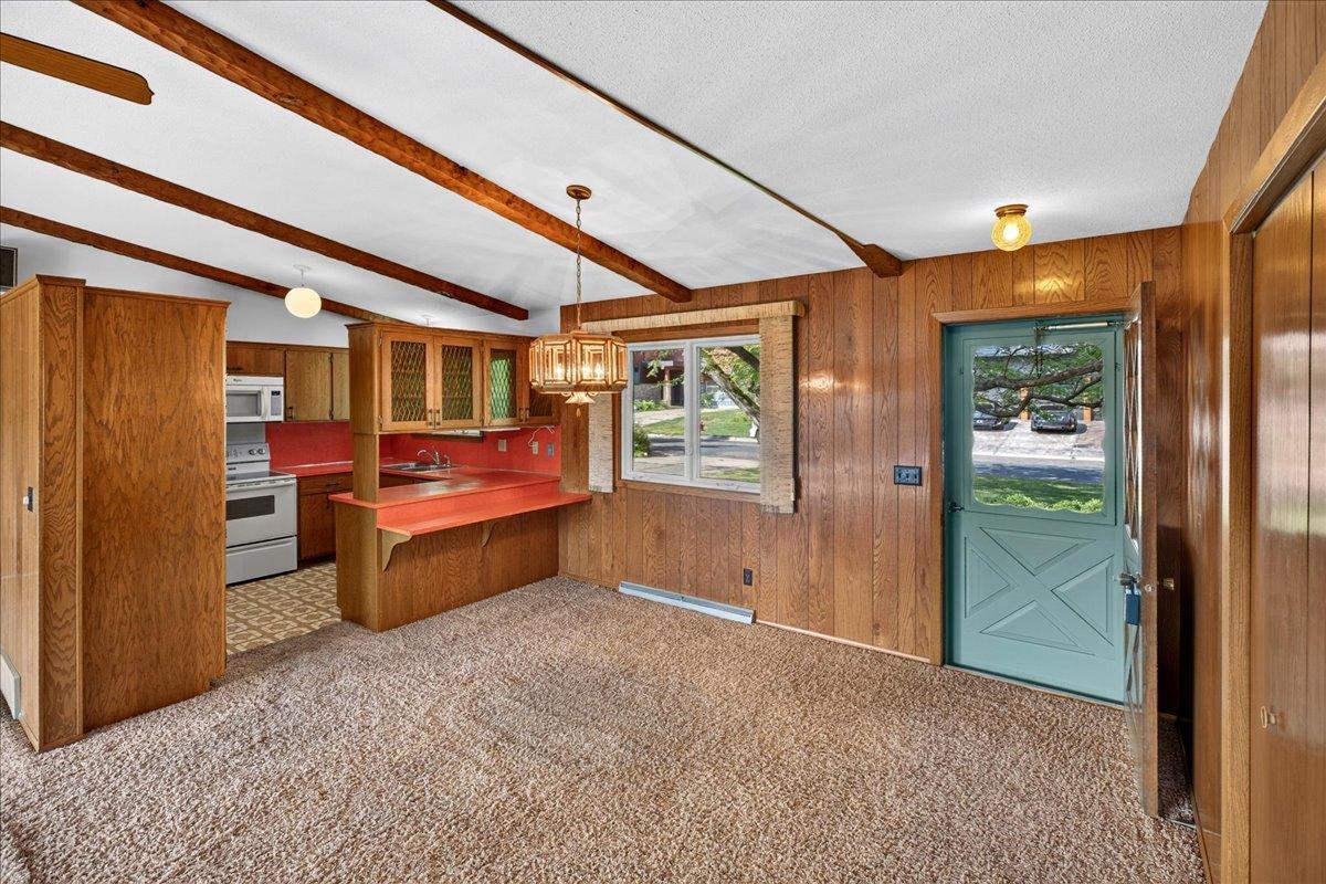 Enter into a dramatic main level with a beamed and vaulted ceiling that covers the main living areas.