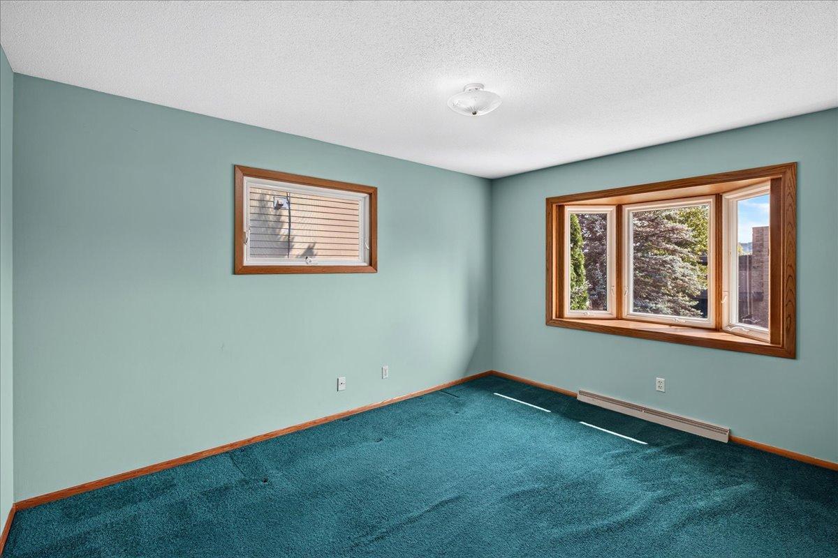 The second bedroom on the main level boasts bayed windows with river views and another window to the side of the home.