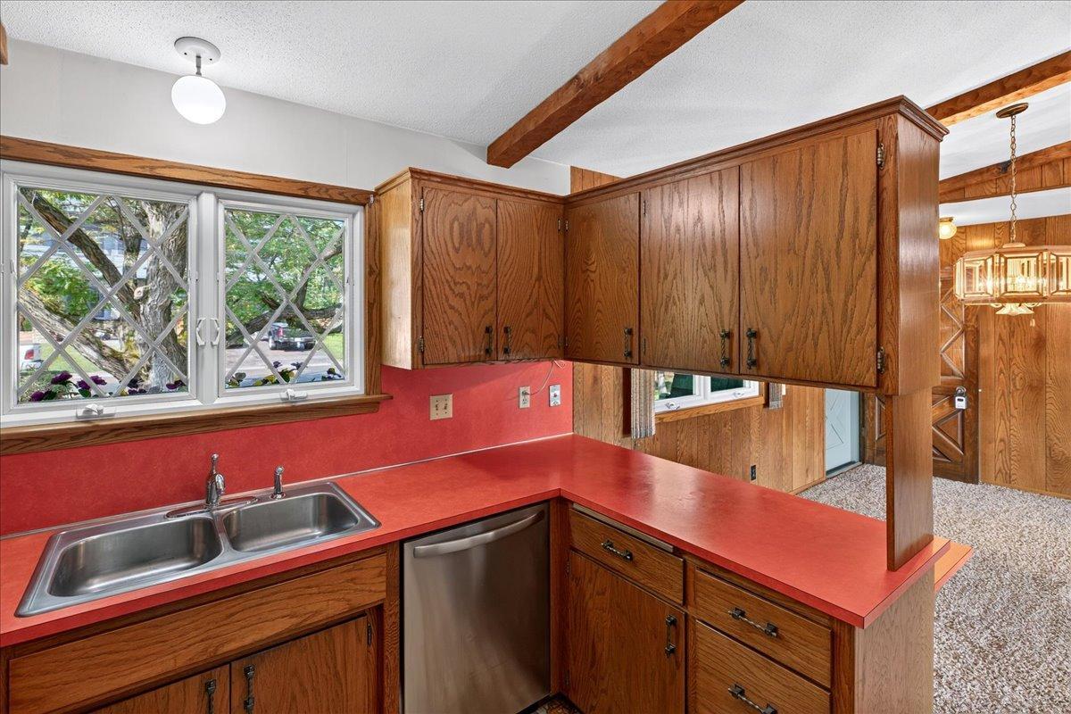 Kitchen boasts a newer dishwasher and window above the sink that looks into the front yard.