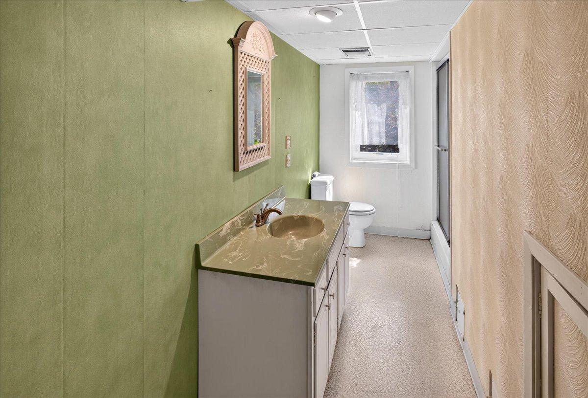Lower level 3/4 bath has a window to the rear of the home.