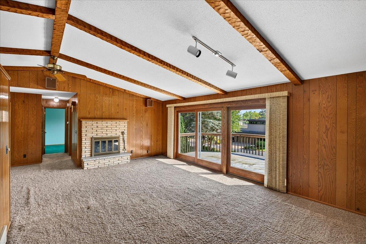 Another view of the living room showcasing the massive sliding glass doors that allow lovely views and lead to the deck.