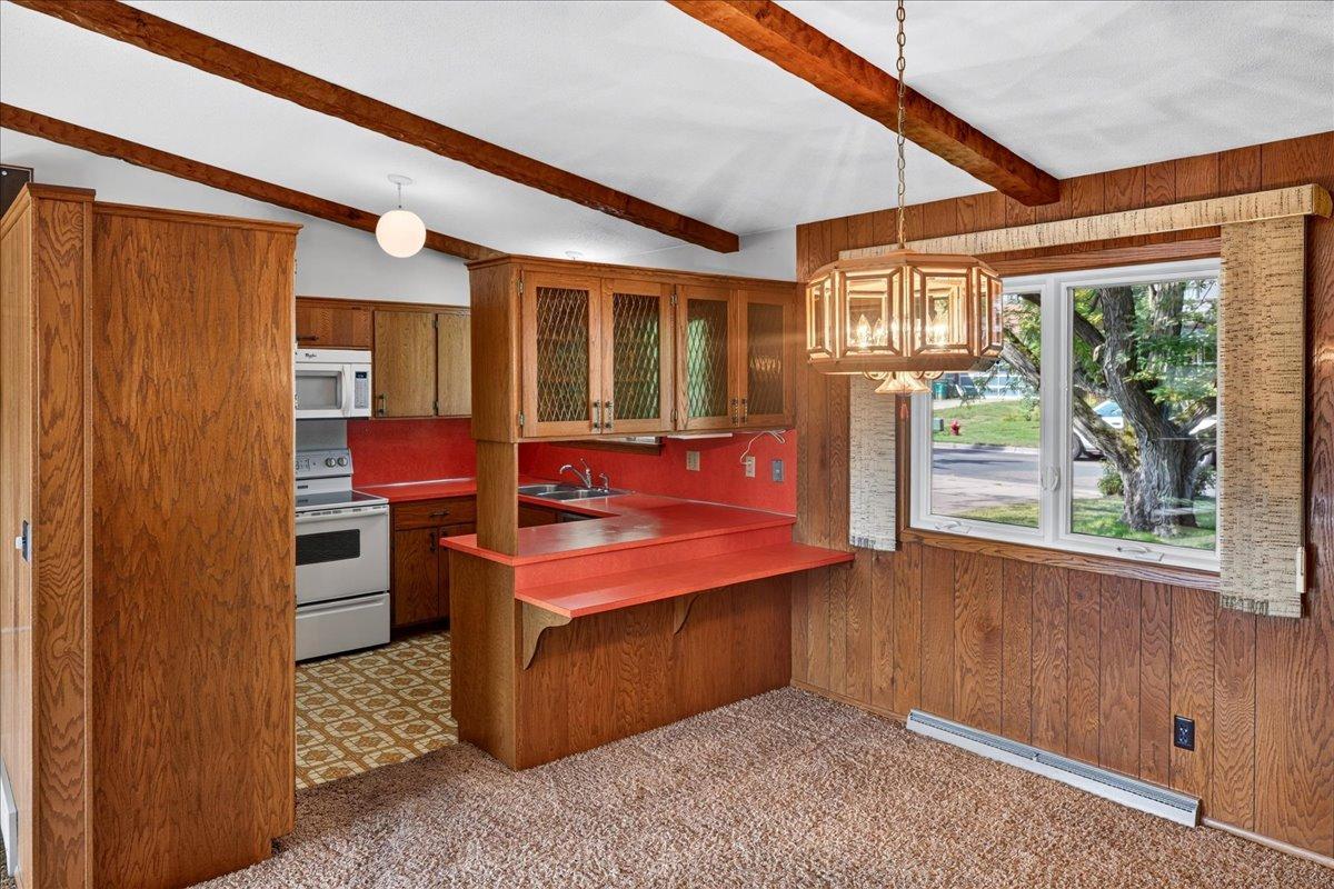 "Vintage" kitchen offers a snack bar and glass fronted cabinets that open to the dining room.