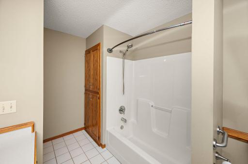 Low maintenance tub/shower surround. Added storage too