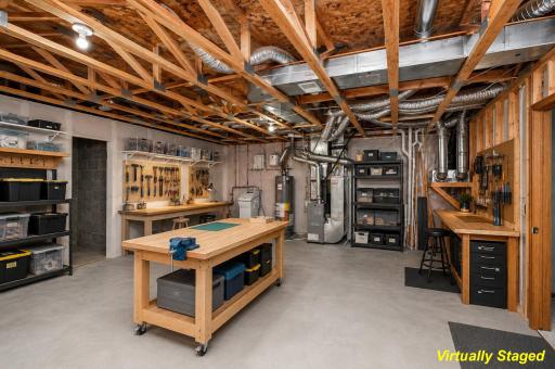 Virtually staged unfinished area to give a sense of how you can add storage and/or workshop