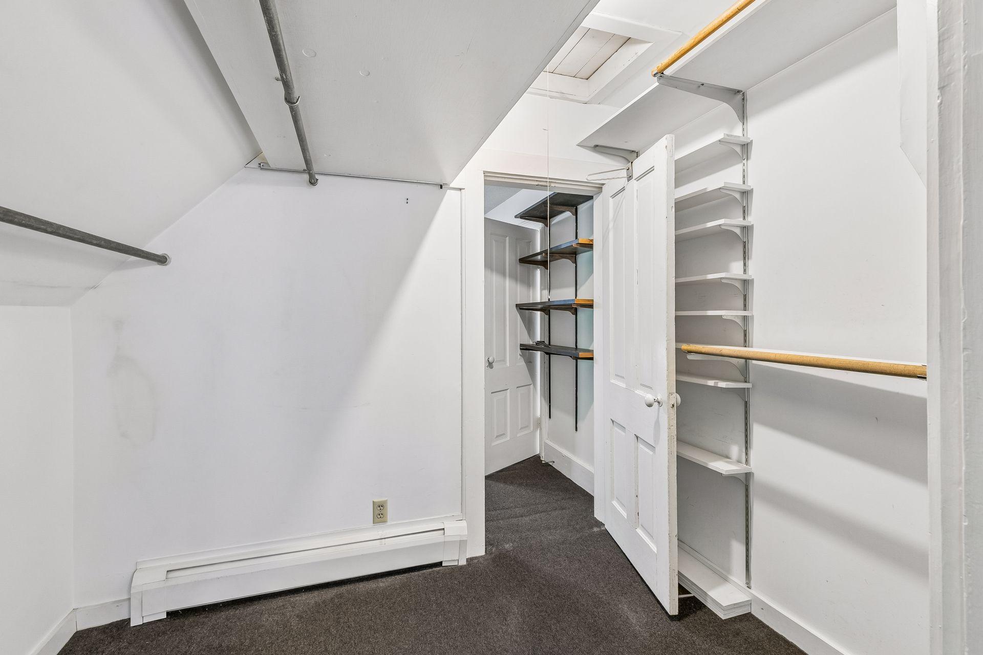 Large walk-in closet between bedroom 1 & 2. The tall bar glides away from the shorter bar to make access easier