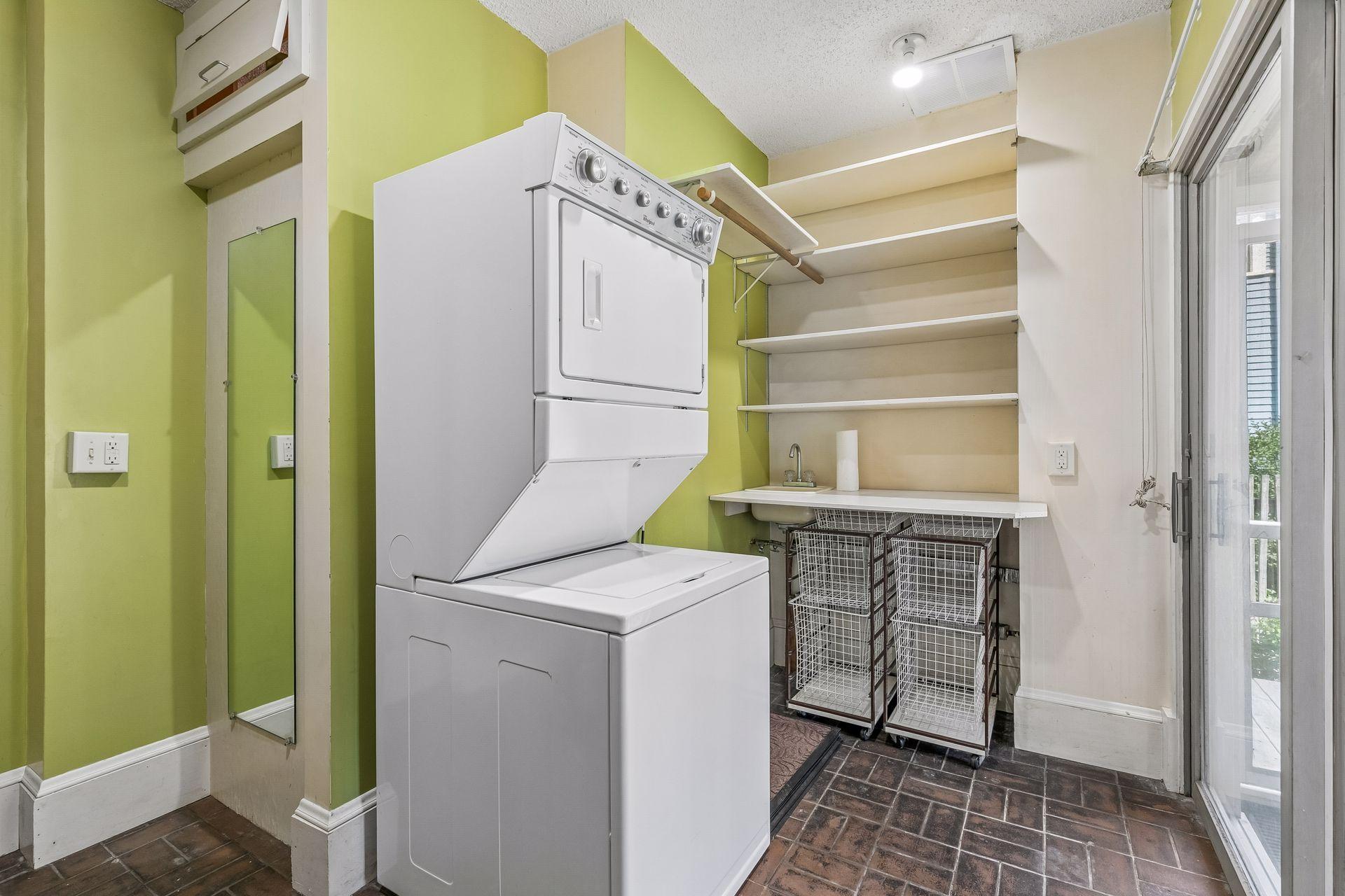 Main floor laundry with brick floor and utility sink - walks out to the screened porch