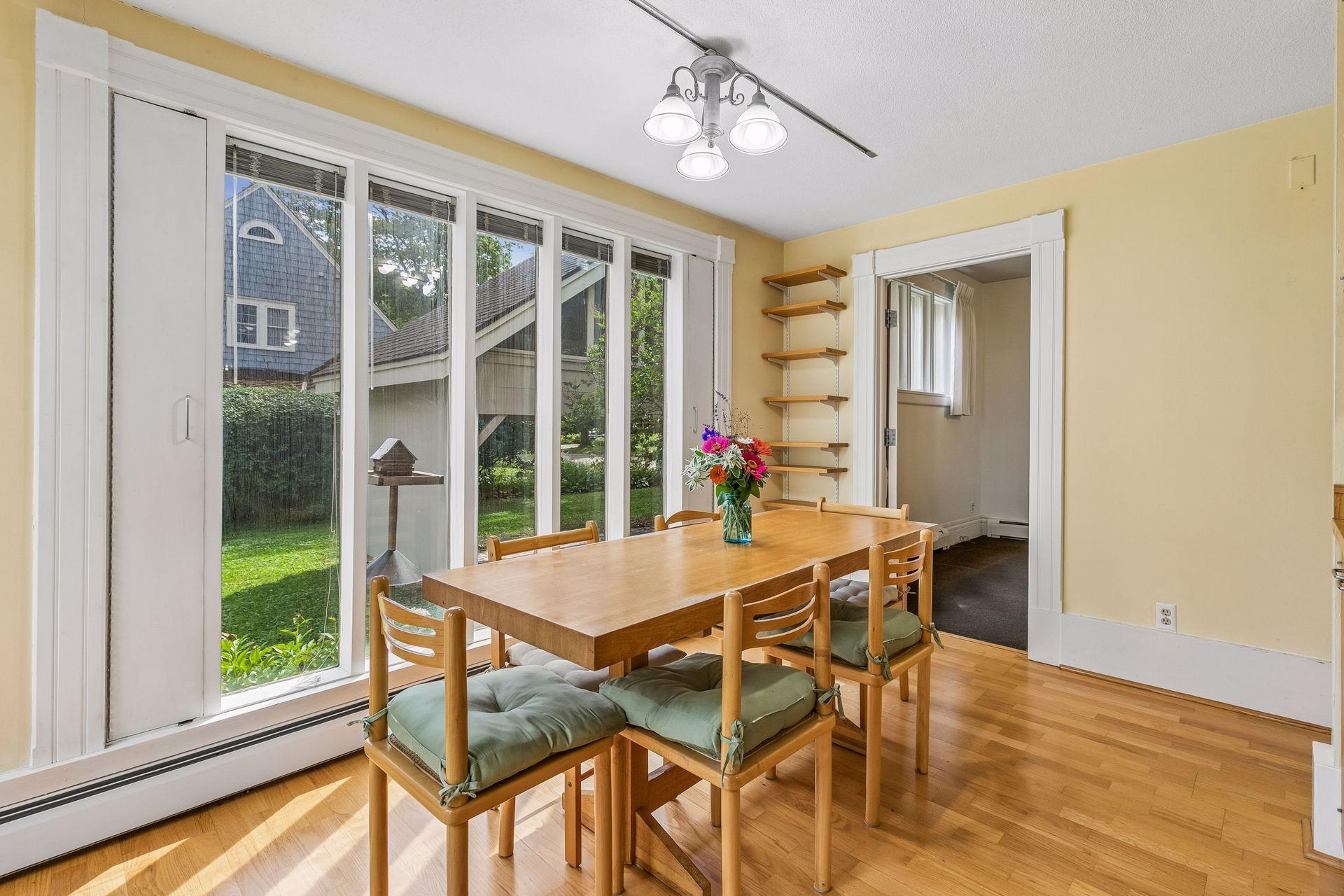 Eat-in Kitchen area surrounded by windows overlooking backyard
