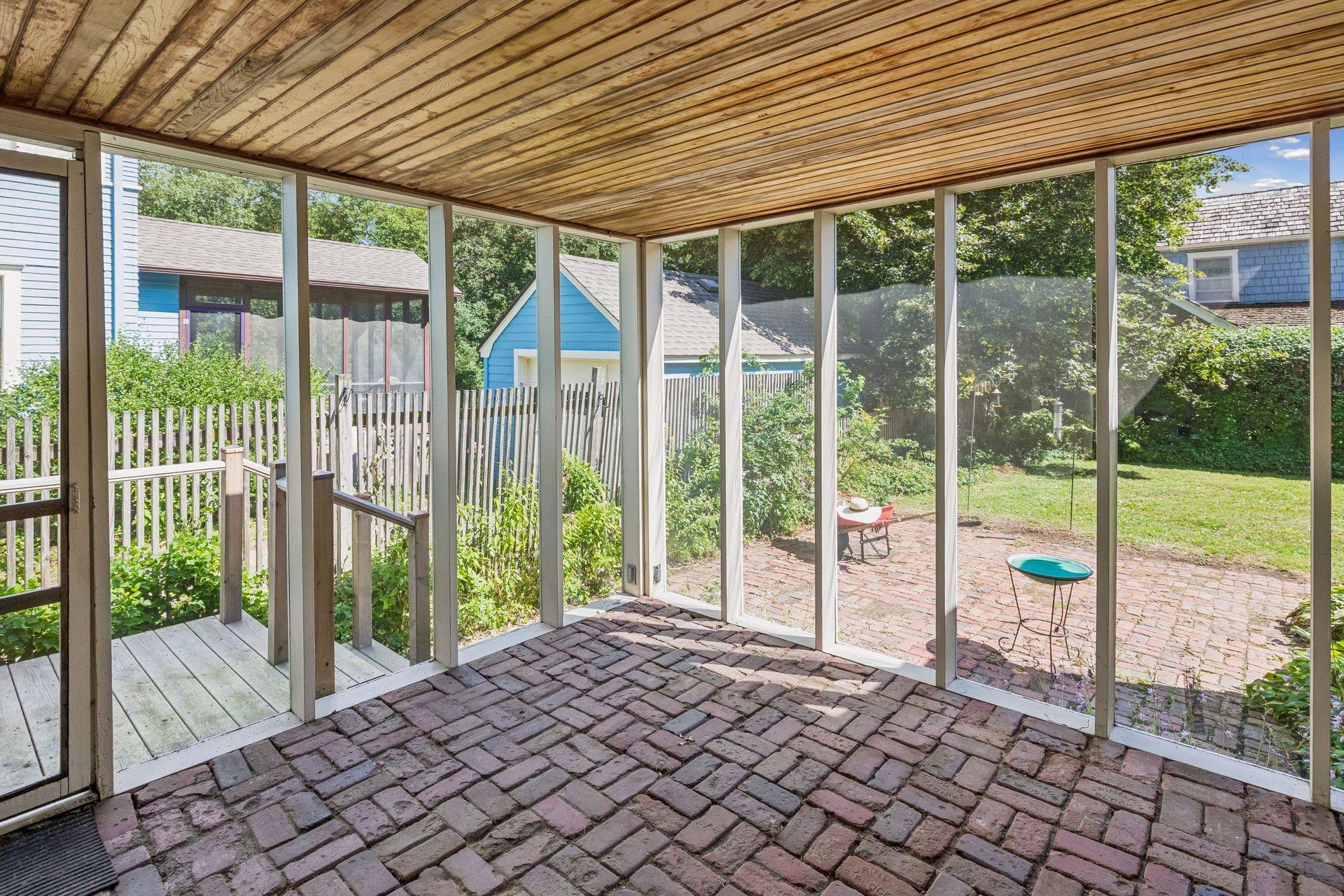 Screened porch off the kitchen and overlooking patio and backyard