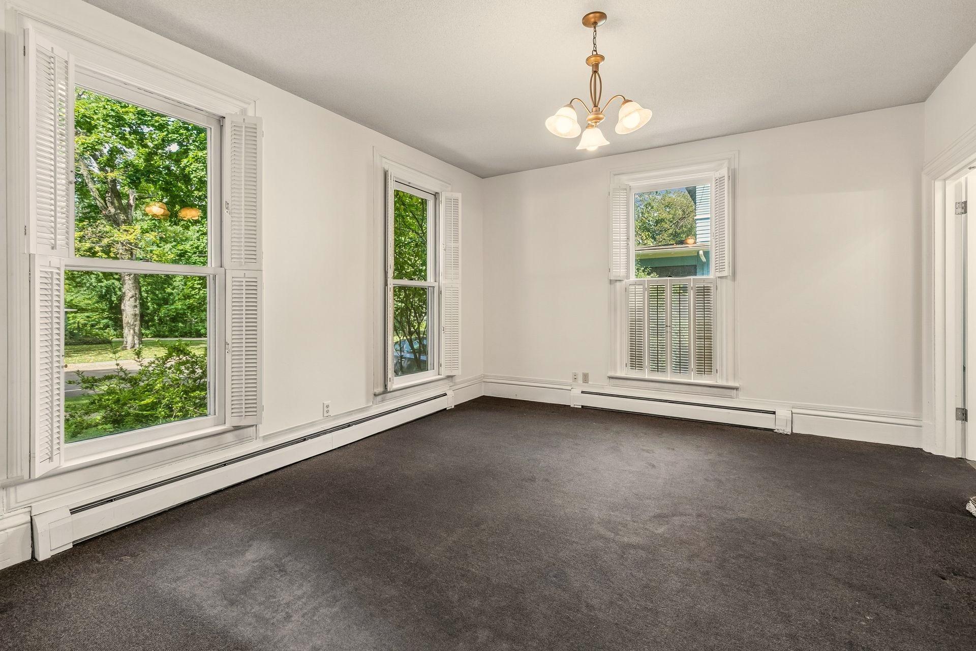 Main level family room or the 5th bedroom with attached shower bath.