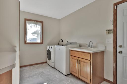 Main floor laundry with base cabinet sink.