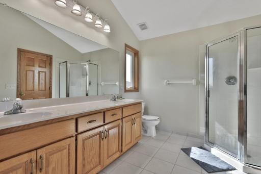 Private owners bathroom with both a tub and shower