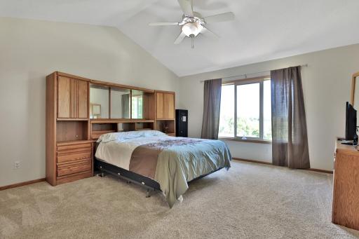 Primary bedroom with vaulted ceiling