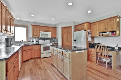 An abundance of cupboard and drawer space. including a desk area off to the right of the photo.