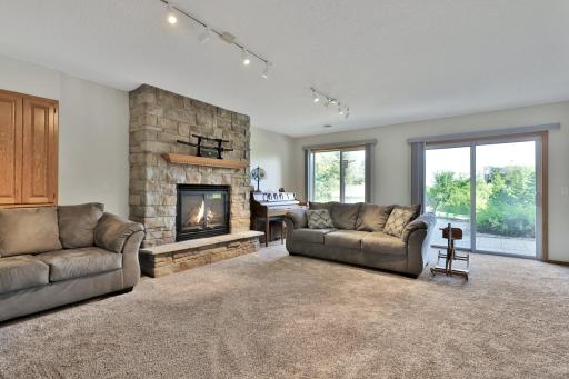 Lower level gas fire place with brick surround and walkout to rear patio