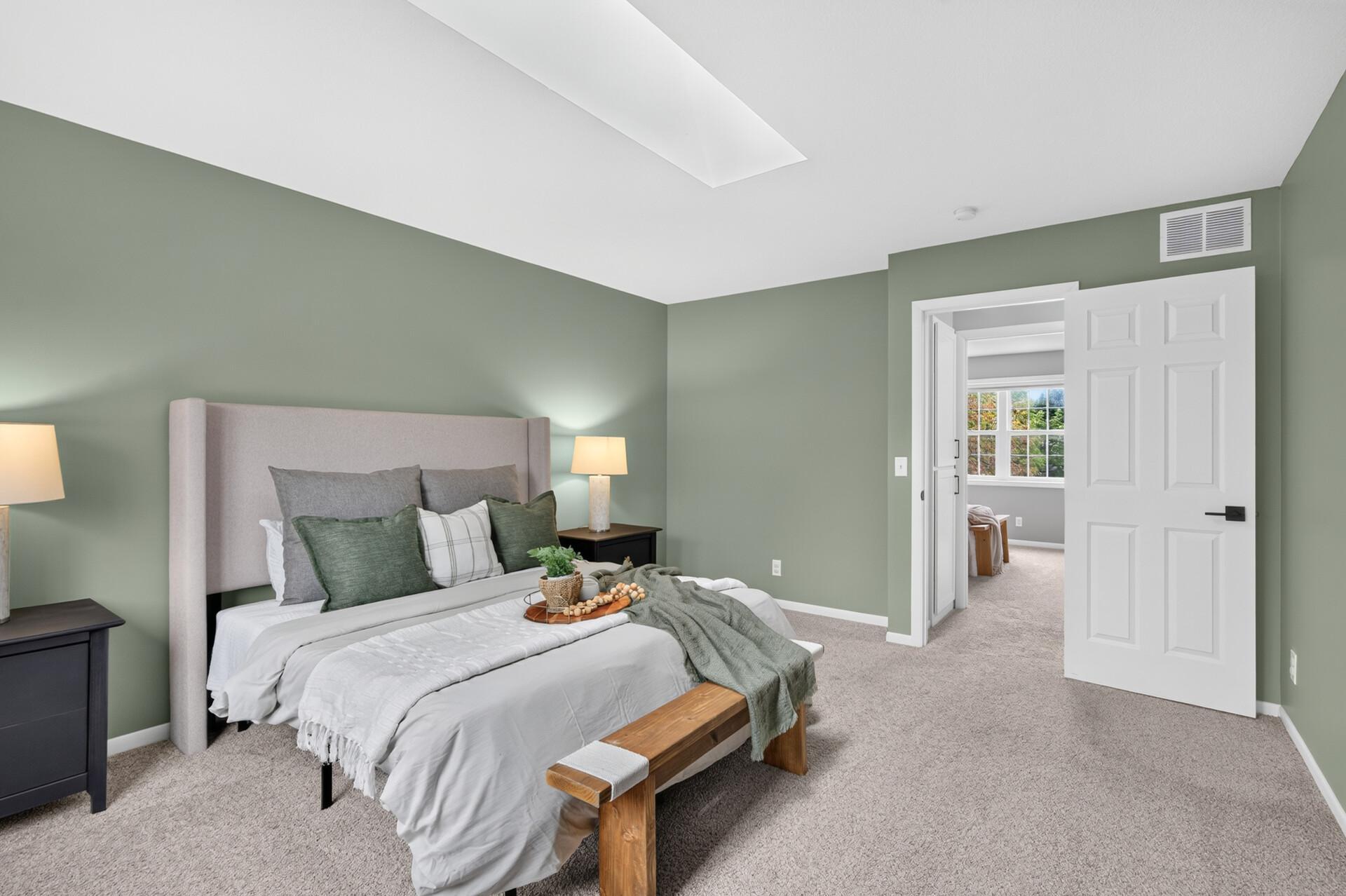 Primary bedroom with skylight and overlooks the backyard