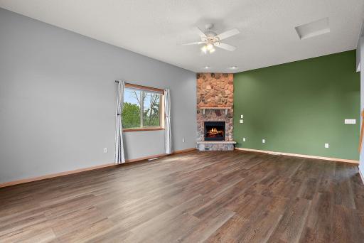 An open living room space with charming stone fireplace
