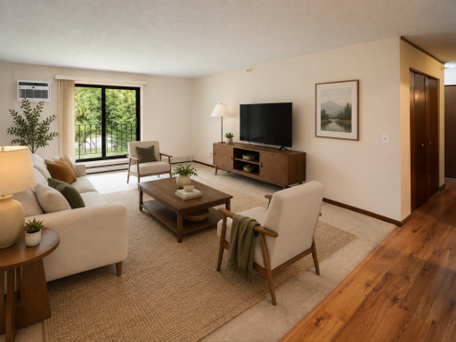 Living room with direct access to the updated private deck overlooking the community’s maintained grounds. *Virtually staged for inspiration*