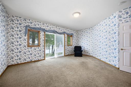 Master Bedroom with newer patio door to paver patio deck, on the lake side