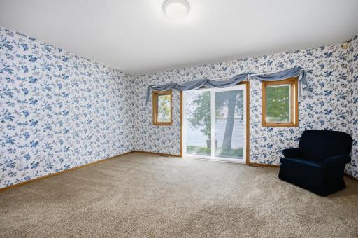 Master Bedroom with newer patio door to paver patio/deck, on lake side